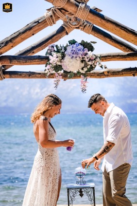 In Lake Tahoe, California, the newlywed couple laughs heartily while enthusiastically engaging in a sandy activity, their genuine joy filling the moment.